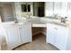 Bright bathroom featuring dual vanity with white cabinets, a large mirror and wood-look flooring at 9424 Fox Forest Ave, Las Vegas, NV 89129