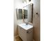 Bathroom with white vanity, decorative mirror, and modern fixtures at 9424 Fox Forest Ave, Las Vegas, NV 89129