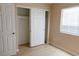 Bedroom features a closet with sliding doors, window, and white door at 9424 Fox Forest Ave, Las Vegas, NV 89129
