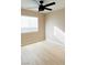 Bedroom with a ceiling fan, natural light, and wood floors at 9424 Fox Forest Ave, Las Vegas, NV 89129