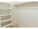 Walk-in closet equipped with built-in white shelving for easy storage and organization at 9424 Fox Forest Ave, Las Vegas, NV 89129