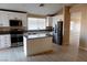 Bright kitchen features stainless steel appliances, granite countertops, and a central island at 9424 Fox Forest Ave, Las Vegas, NV 89129