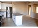Open kitchen with a granite island, stainless steel refrigerator and recessed lights at 9424 Fox Forest Ave, Las Vegas, NV 89129