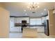 Bright kitchen featuring white cabinets, stainless steel appliances, and granite countertops at 9424 Fox Forest Ave, Las Vegas, NV 89129