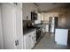 Stylish kitchen featuring modern appliances, granite countertops and sleek, white cabinetry at 9424 Fox Forest Ave, Las Vegas, NV 89129