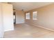 Open-concept living room with modern light fixture, and large windows letting in natural light at 9424 Fox Forest Ave, Las Vegas, NV 89129