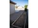 Side yard featuring a potential garden bed along the block wall and a concrete patio area at 9424 Fox Forest Ave, Las Vegas, NV 89129