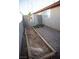 Side yard featuring a potential garden bed along the block wall with a view of a gated entrance at 9424 Fox Forest Ave, Las Vegas, NV 89129