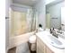 Bright bathroom featuring a tub with shower, white vanity, and decorative leafy shower curtain at , Las Vegas, NV 89183