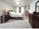 Spacious bedroom with plush carpeting, dark furniture, and a sunny window at , Las Vegas, NV 89183