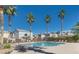 Community swimming pool surrounded by lounge chairs and palm trees for relaxation and recreation at , Las Vegas, NV 89183