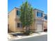 Corner view of a charming two-story home with a well-maintained front yard and car parked in the driveway at , Las Vegas, NV 89183