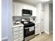 Modern kitchen with stainless steel oven and stovetop, white cabinets, and modern appliances at , Las Vegas, NV 89183