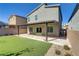 Backyard showing the covered patio, artificial turf, and block wall providing privacy to enjoy the outdoor space at 10785 Wild Parsley Ave, Las Vegas, NV 89129