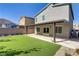 Beautiful backyard featuring artificial turf, a covered patio, and tasteful desert landscaping providing the perfect relaxation area at 10785 Wild Parsley Ave, Las Vegas, NV 89129