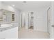 A light-filled bathroom featuring double sinks, a walk-in shower, and a separate toilet room for added privacy at 10785 Wild Parsley Ave, Las Vegas, NV 89129