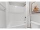 Clean white shower and tub combination with tiled wall and shower curtain at 10785 Wild Parsley Ave, Las Vegas, NV 89129