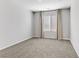 Bright bedroom featuring neutral walls, carpeting, window with blinds and curtains at 10785 Wild Parsley Ave, Las Vegas, NV 89129