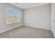 Bedroom featuring neutral walls, plush carpeting, and a window providing natural light at 10785 Wild Parsley Ave, Las Vegas, NV 89129