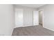 Bedroom featuring neutral walls, plush carpeting, and two doors that provide access to a bathroom and closet at 10785 Wild Parsley Ave, Las Vegas, NV 89129