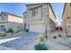 Two-story home featuring desert landscaping and a brick paver driveway, offering curb appeal at 10785 Wild Parsley Ave, Las Vegas, NV 89129