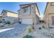 Two-story home featuring desert landscaping and a brick paver driveway, offering curb appeal at 10785 Wild Parsley Ave, Las Vegas, NV 89129