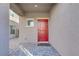 Inviting covered entry featuring a stylish red door and brick pavers, adding charm at 10785 Wild Parsley Ave, Las Vegas, NV 89129