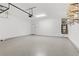 Spacious garage with epoxy flooring, overhead lighting, and shelving at 10785 Wild Parsley Ave, Las Vegas, NV 89129