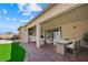 Inviting outdoor living area with covered patio, outdoor seating, and artificial turf at 1091 E Sunset Rd, Henderson, NV 89011