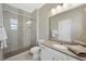 A modern bathroom featuring a glass shower, gray tile and single sink at 1091 E Sunset Rd, Henderson, NV 89011