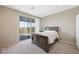 This bedroom features a large sliding glass door with an outdoor view and neutral decor at 1091 E Sunset Rd, Henderson, NV 89011