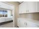 Neutral bedroom with white cabinets and sliding glass door with an outdoor view at 1091 E Sunset Rd, Henderson, NV 89011