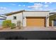 Detached two-car garage with a neutral color palette and brick paved driveway at 1091 E Sunset Rd, Henderson, NV 89011