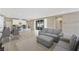 Open-concept living room and kitchen with modern gray sofa and stylish bar seating at 1091 E Sunset Rd, Henderson, NV 89011