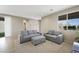 Cozy living room with gray sofas, an ottoman, and a view of the neighborhood at 1091 E Sunset Rd, Henderson, NV 89011