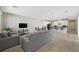 Bright living room featuring contemporary furniture, wood-look floors, and open access to the kitchen at 1091 E Sunset Rd, Henderson, NV 89011