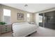 Well-lit main bedroom with a large window, dresser, and comfortable furnishings at 1091 E Sunset Rd, Henderson, NV 89011