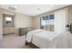 Bright main bedroom with a sliding glass door to the outside and a stylish dresser at 1091 E Sunset Rd, Henderson, NV 89011