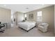 Bright, neutral main bedroom with a desk, plush chair, and access to a modern bathroom at 1091 E Sunset Rd, Henderson, NV 89011