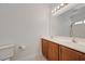 Bathroom featuring a dual-sink vanity with wooden cabinets at 1163 Tumbling River Ave, Henderson, NV 89052