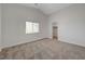 Carpeted bedroom featuring neutral paint, white trim, window offering natural light, and closet entrance at 1163 Tumbling River Ave, Henderson, NV 89052