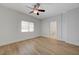 Well-lit bedroom with a large window, ceiling fan, and ensuite bathroom at 1163 Tumbling River Ave, Henderson, NV 89052