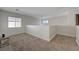 Carpeted second-floor area with windows for natural light at 1163 Tumbling River Ave, Henderson, NV 89052