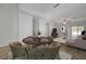 Staged living room with an open floor plan, dining area, and stylish furniture at 1163 Tumbling River Ave, Henderson, NV 89052