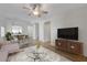 Staged living room featuring an open floor plan, new floors, and modern furniture at 1163 Tumbling River Ave, Henderson, NV 89052