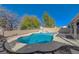 Inviting pool and spa surrounded by stone landscaping and a secure fence for Gathering-friendly fun at 1163 Tumbling River Ave, Henderson, NV 89052