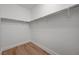 Walk-in closet with ample hanging space and wood-look floors at 1163 Tumbling River Ave, Henderson, NV 89052