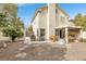 View of backyard with covered patio, desert landscaping, and charming two-story home at 1216 Maserati Dr, Las Vegas, NV 89117