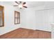 Well-lit room with a ceiling fan, wood-look floors, closet and shuttered windows at 1216 Maserati Dr, Las Vegas, NV 89117