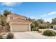 Charming two-story home features neutral stucco, tile roof, well-maintained landscaping, and attached garage at 1216 Maserati Dr, Las Vegas, NV 89117